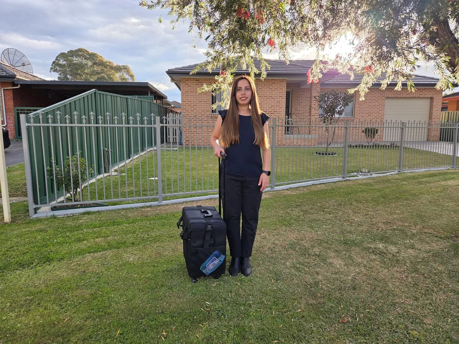Madleen with her mobile podiatry case outside a Sydney home, ready for a home visit