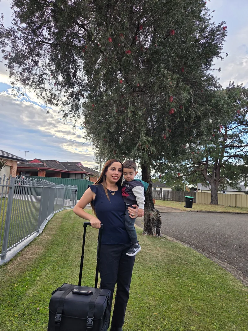 Madleen arriving for a home visit with her mobile podiatry case and a young patient outside a Sydney home
